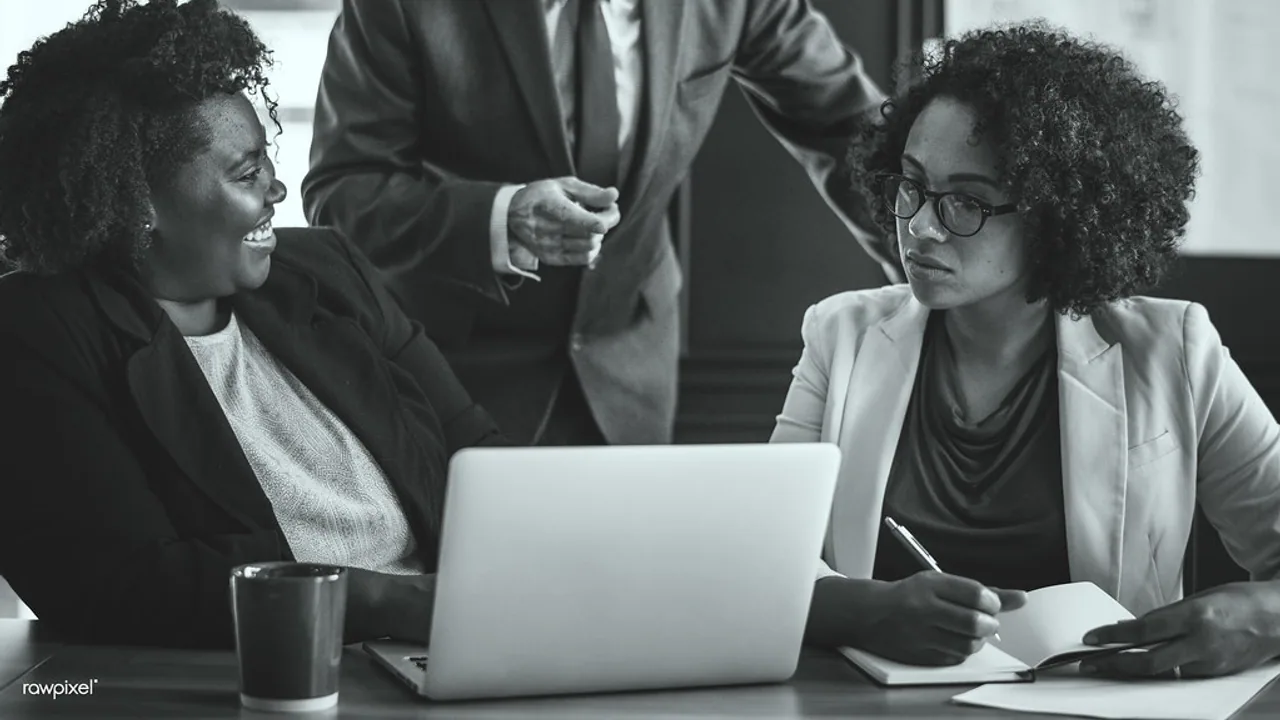 Business people meeting around a laptop