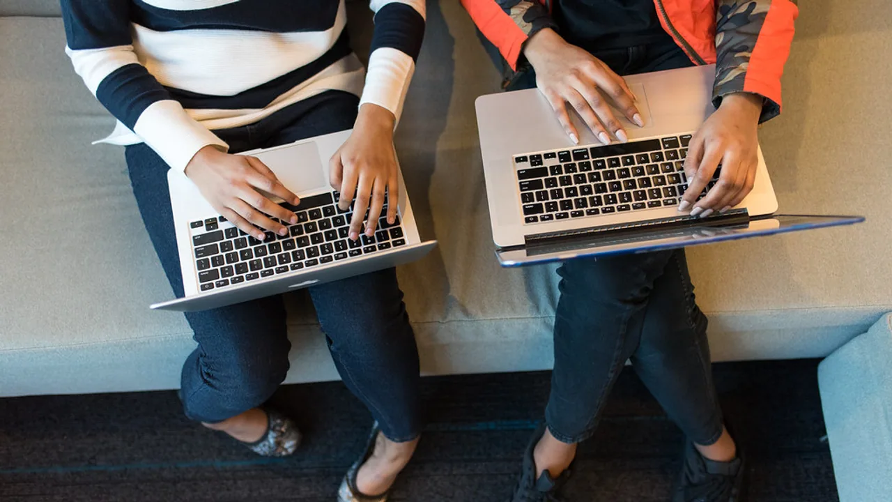People working together with laptops in a startup-style workspace