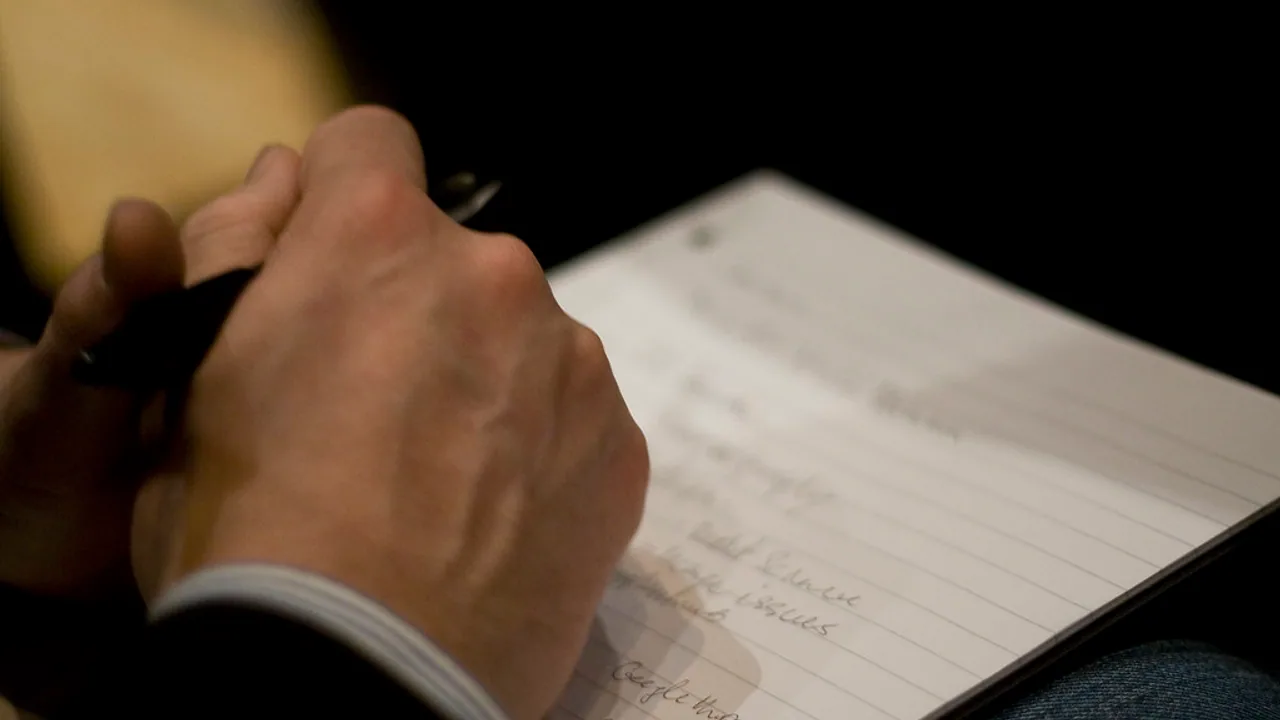 Person taking notes on paper during work